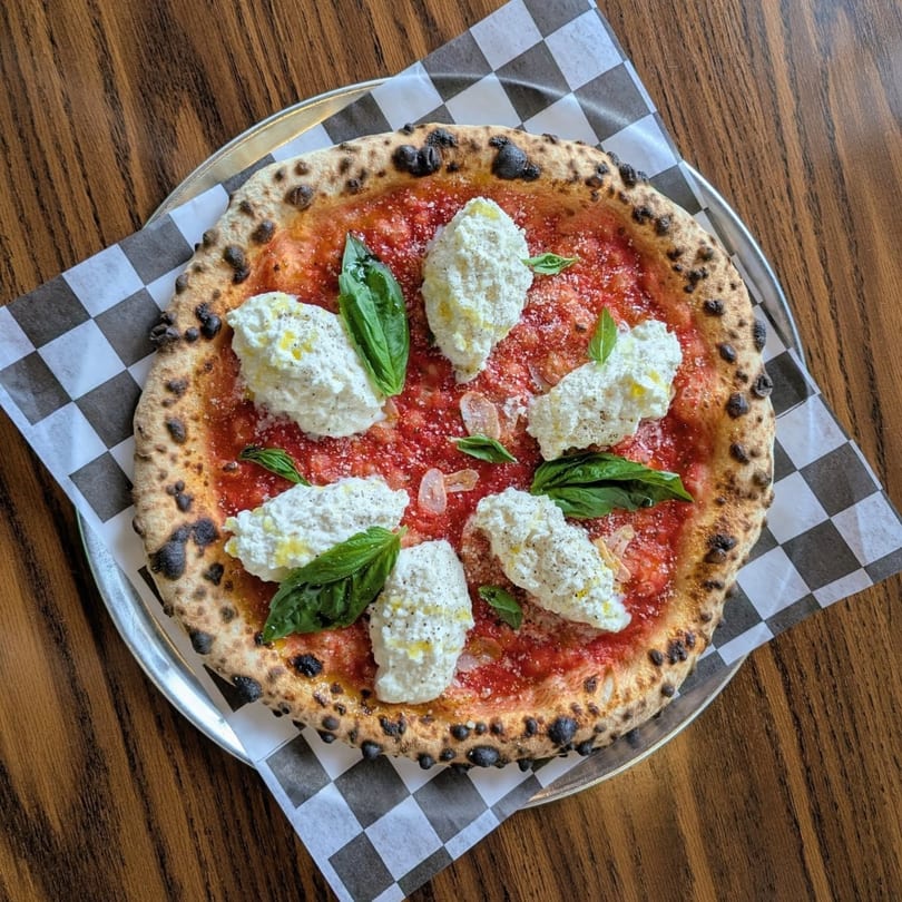 Pop-Start Pizza's Margherita pizza with large dollops of ricotta cheese and fresh basil leaves.